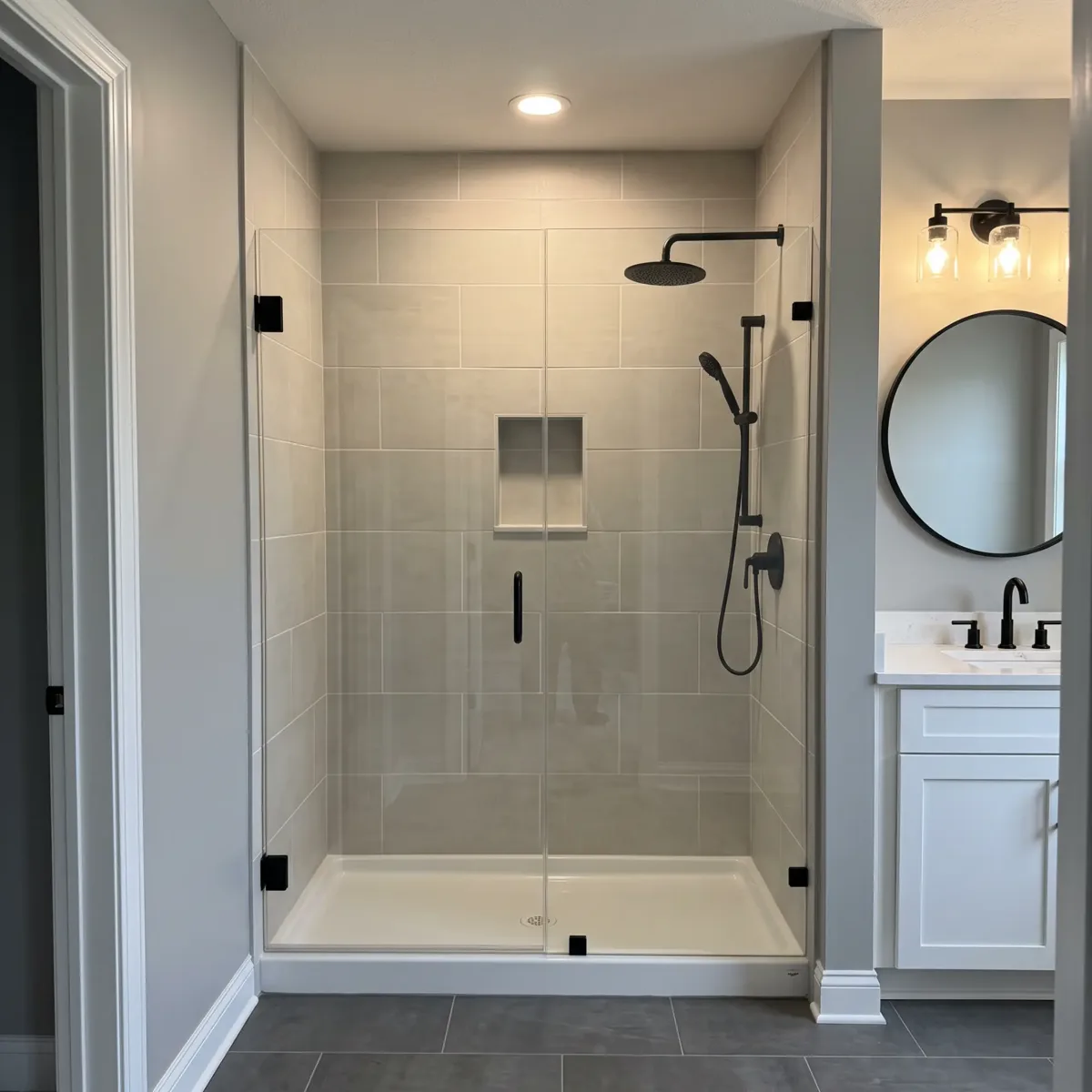 Tiled shower with glass doors and black fixtures